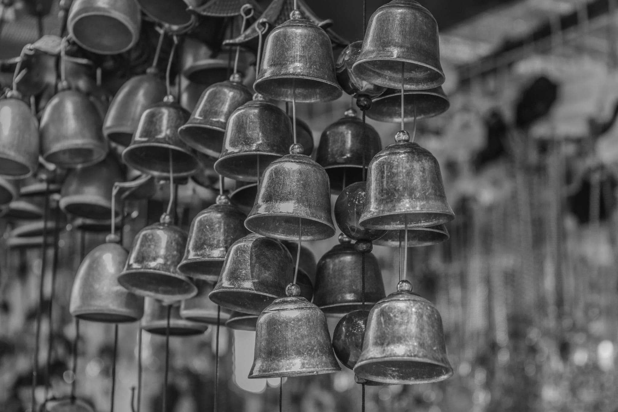 Dozens of small metal bells hanging close together