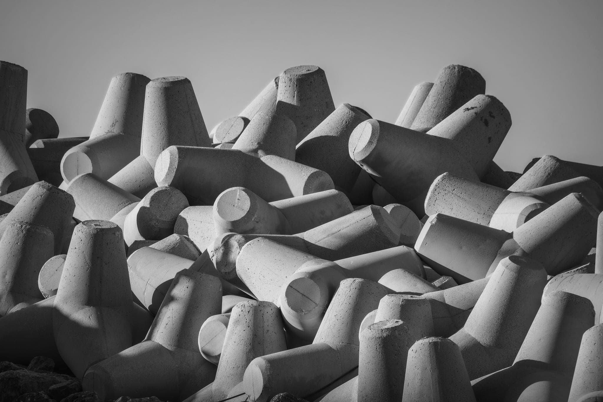 A cluster of concrete breakwater blocks piled together