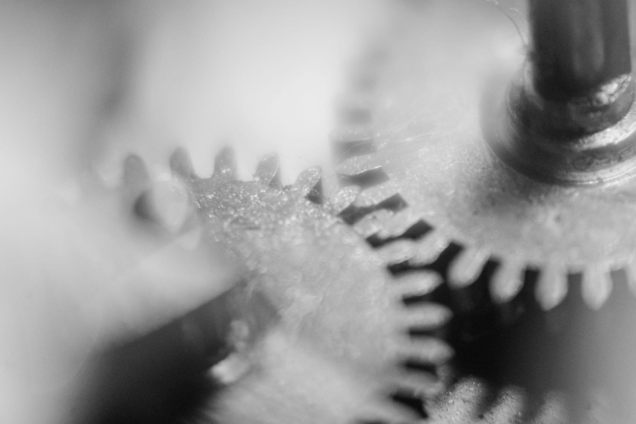 Macro close-up of small metal gears, their teeth meshing