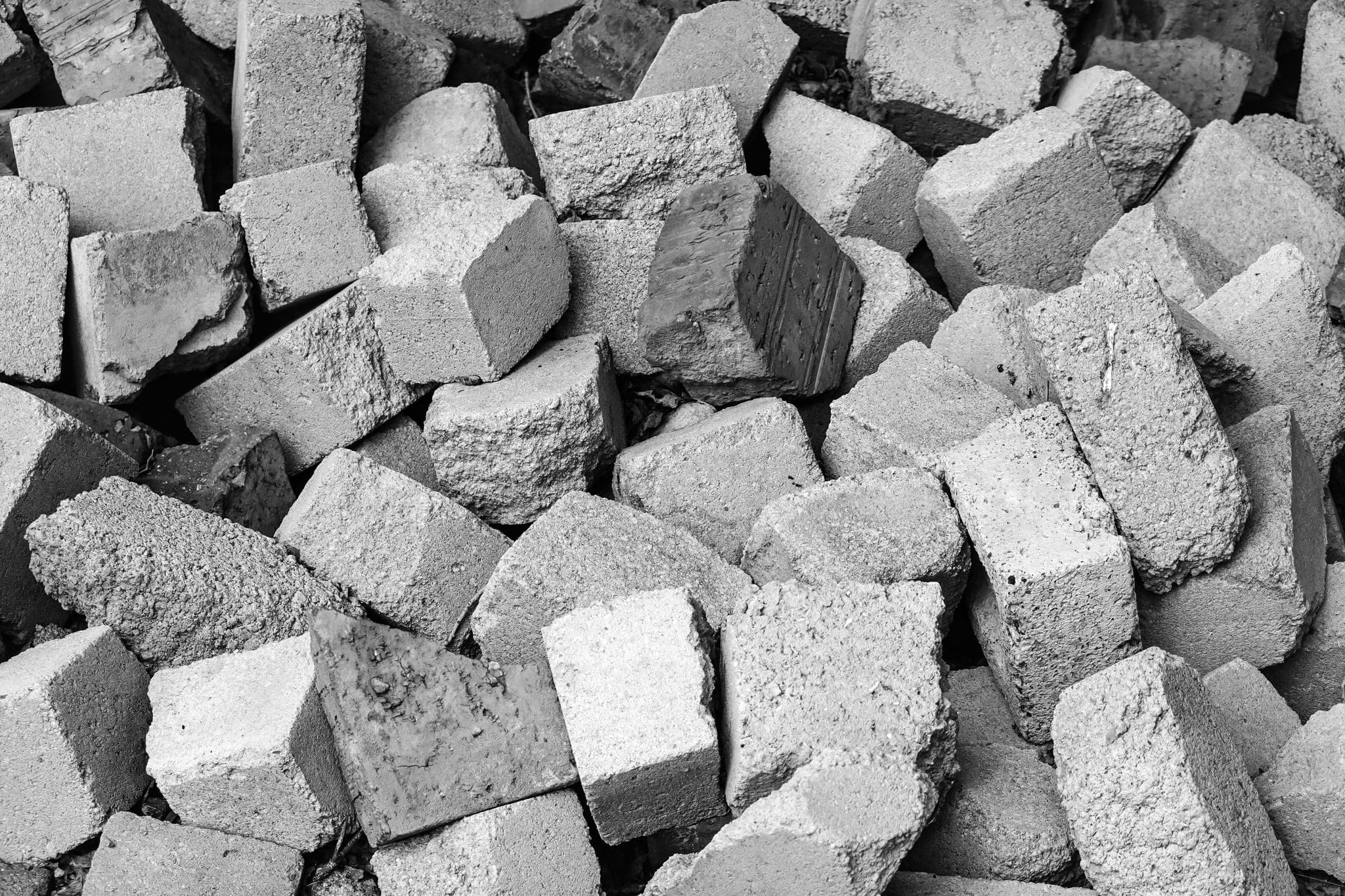 A heap of rough bricks and concrete blocks piled together