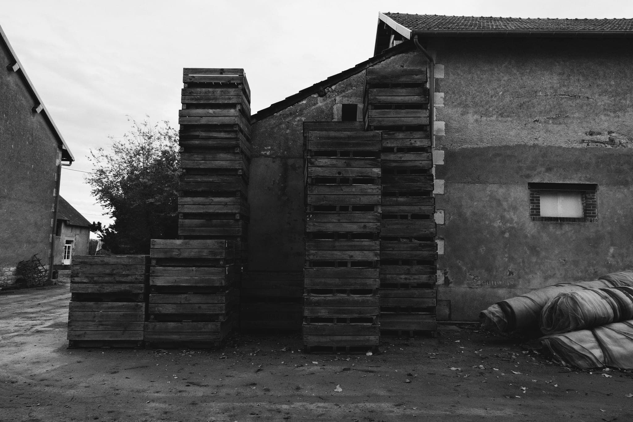 Stacks of weathered wooden crates in a yard