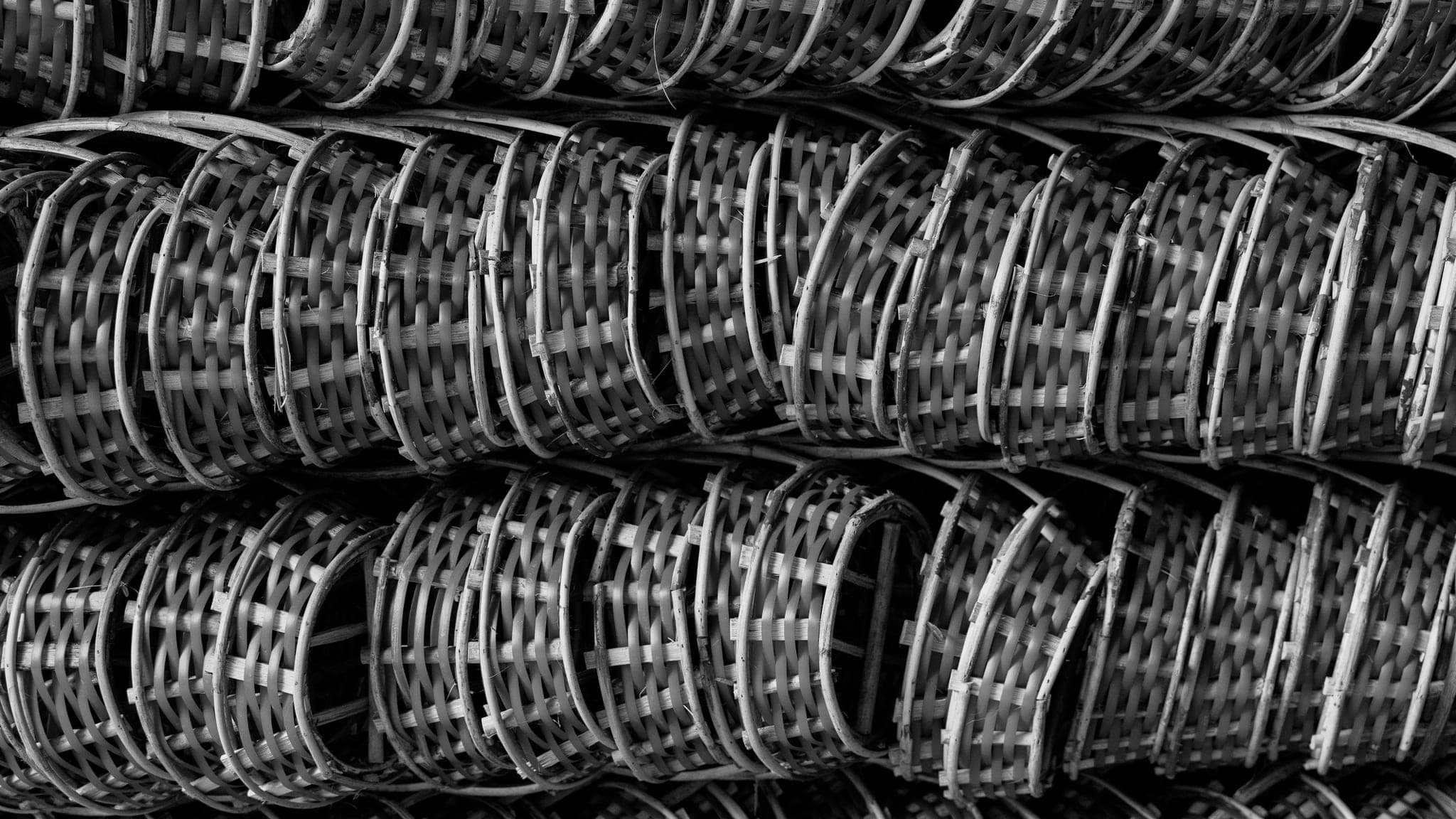 Stacks of woven bamboo baskets arranged at a Vietnamese market